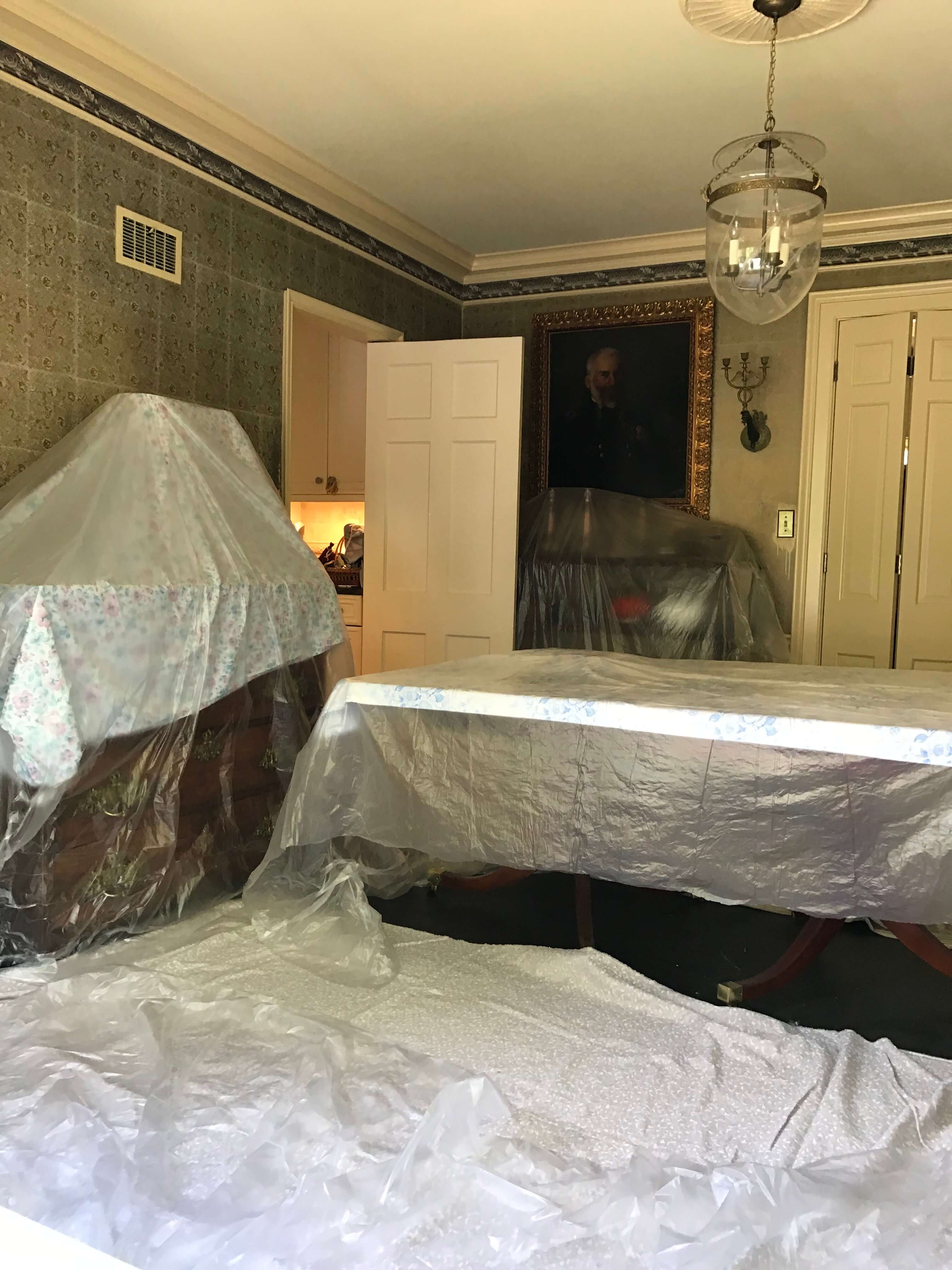 Covering all the furniture and floor with plastic sheeting